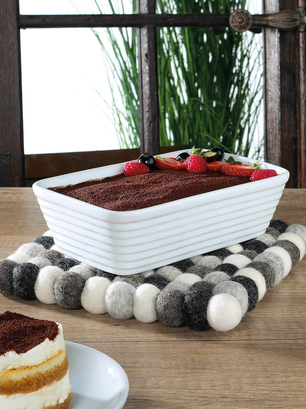 Lana Grigio wool trivet under a porcelain baking dish
